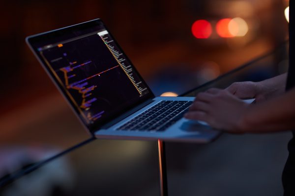 Hacker, code and laptop with hands of person for ransomware, cyber security and phishing. Coding, technology and crime with closeup of programmer for fraud, network system and data scam at night.
